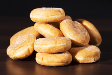 Group of fresh baked cinnamon donuts with raspberry jam. 