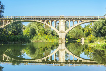 Fototapeta premium Reflection of bridge over river