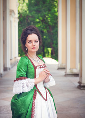 Beautiful young  woman in green medieval dress