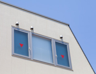 Detail of house exterior wall and window.