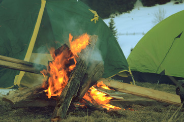 Campfire during rest near tents at night