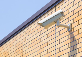 Video camera security system on the wall of the building.