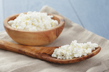 cottage cheese in wood bowl on blue wooden table