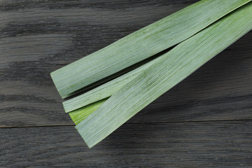 fresh organic leek on vintage oak table
