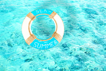 Lifebuoy on water background