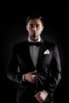 Elegant man in suit on dark background