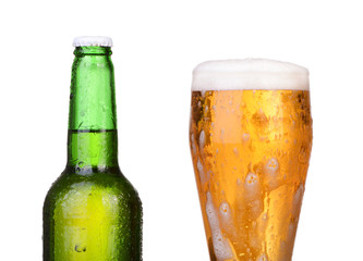 Chilled green bottle with condensate and a glass of beer lager 