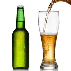 Pouring beer from bottle isolated on white 