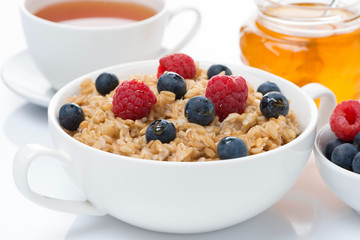 breakfast - oat porridge with fresh berries and honey, black tea