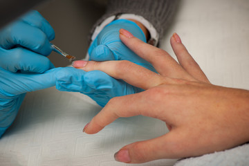 Making hand nails in a professional hand care salon - manicure