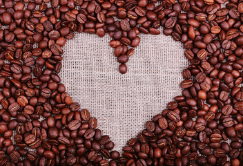 Heart coffee frame made of coffee beans on burlap texture
