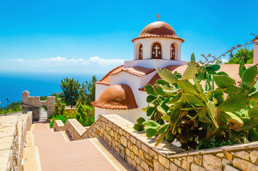 Greek's church with a panorama of a sea and blue sky, Greece - obrazy, fototapety, plakaty