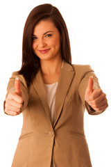 Successful young business woman showing thumbs up as a gesture f