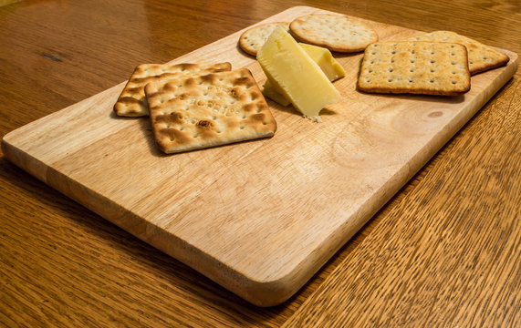 Wooden Cheeseboard on a Dining Table