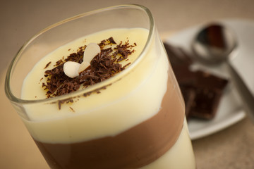 Mixed chocolate and vanilla pudding served in a glass decorated