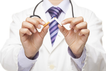  Doctor breaking a cigarette, stop smoking concept.