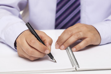 Close up Human Hand Signing on Formal Paper