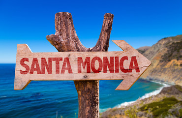 Santa Monica wooden sign with coast background