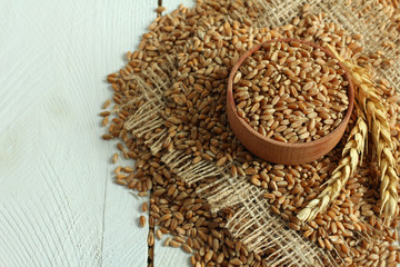 Raw organic spelt on a wooden table