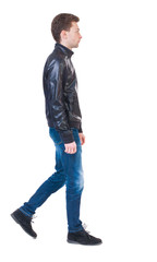 Fototapeta premium Back view of going handsome man in jacket.