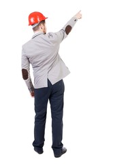 Back view of  pointing young men in helmet.