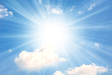 blue sky with little white clouds and sun