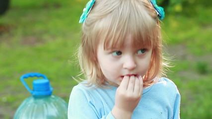 Girl sucking hand on nature