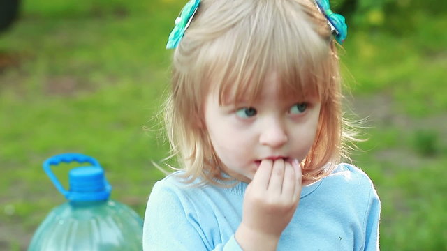 Girl sucking hand on nature