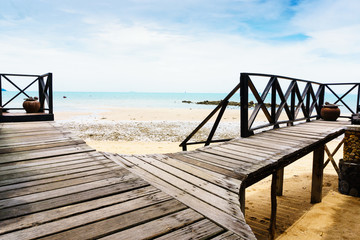 wooden walkway on beach with ocean view in background