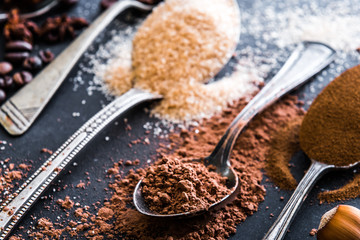 Chocolate powder cocoa and coffee spoons on the table