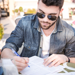 man signing a contract