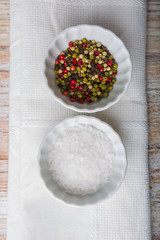 Salt and pepper in white bowls