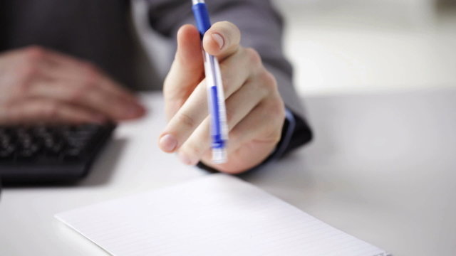 close up of businessman hands with notepad