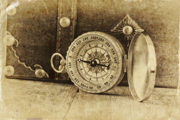 Fototapeta na wymiar antique compass on wooden table. black and white style 