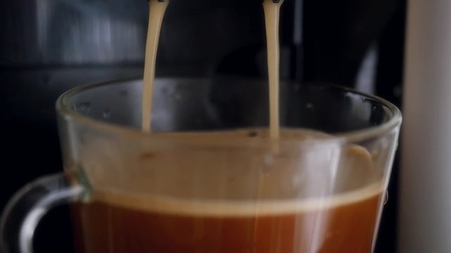 Slowmotion pouring Coffee dispenser with cup of coffee. 