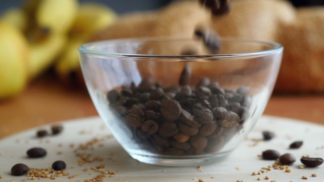 Putting the coffee beans in a transparent Coffee cup