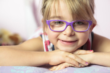 Photo of beautiful kid girl on bed at home