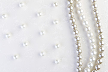 White pearls necklace on white paper