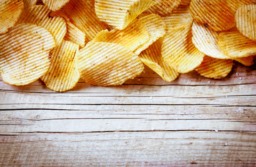 Heap of Paprika Potato Chips on rustic background