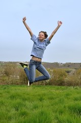 Fototapeta premium Girl jumping in a garden
