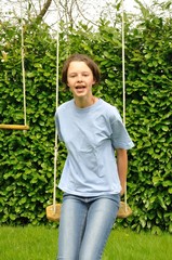 A girl playing in a swing