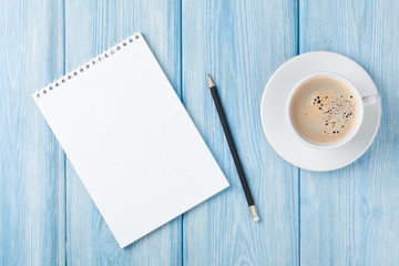 Coffee cup and blank notepad