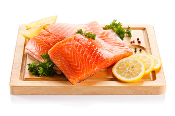 Fresh raw salmon steaks on cutting board 