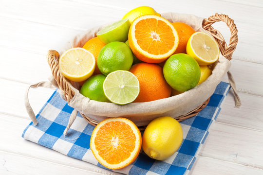 Citrus fruits in basket. Oranges, limes and lemons