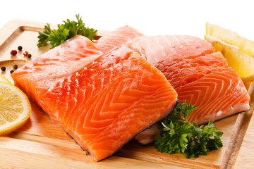 Fresh raw salmon steaks on cutting board 