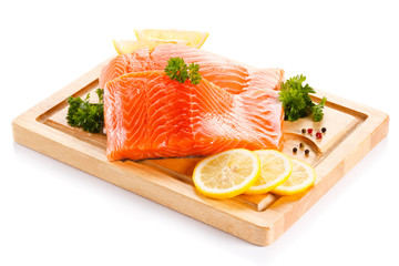 Fresh raw salmon steaks on cutting board 