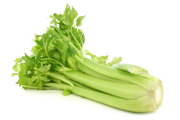 fresh celery stems on a white background © tpzijl
