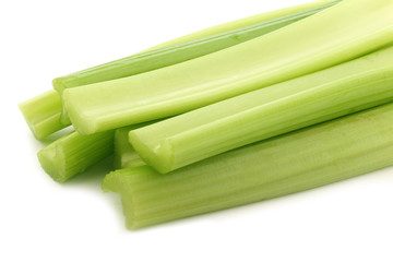 fresh celery stems on a white background