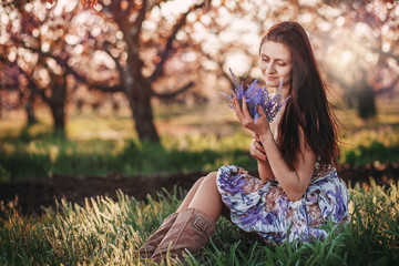 Portrait of beautiful girl in spring orchard