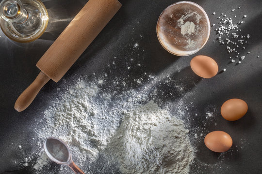 flour and ingredients on black table